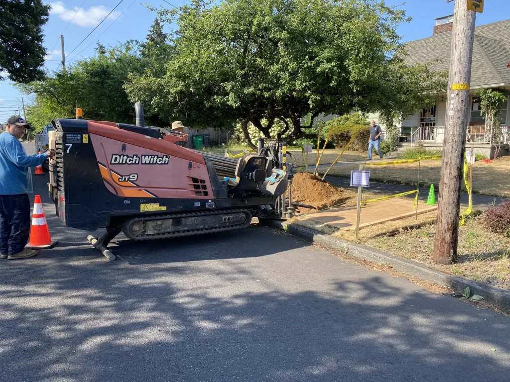 Directional boring rig replacing a main water line at the street with minimal excavation