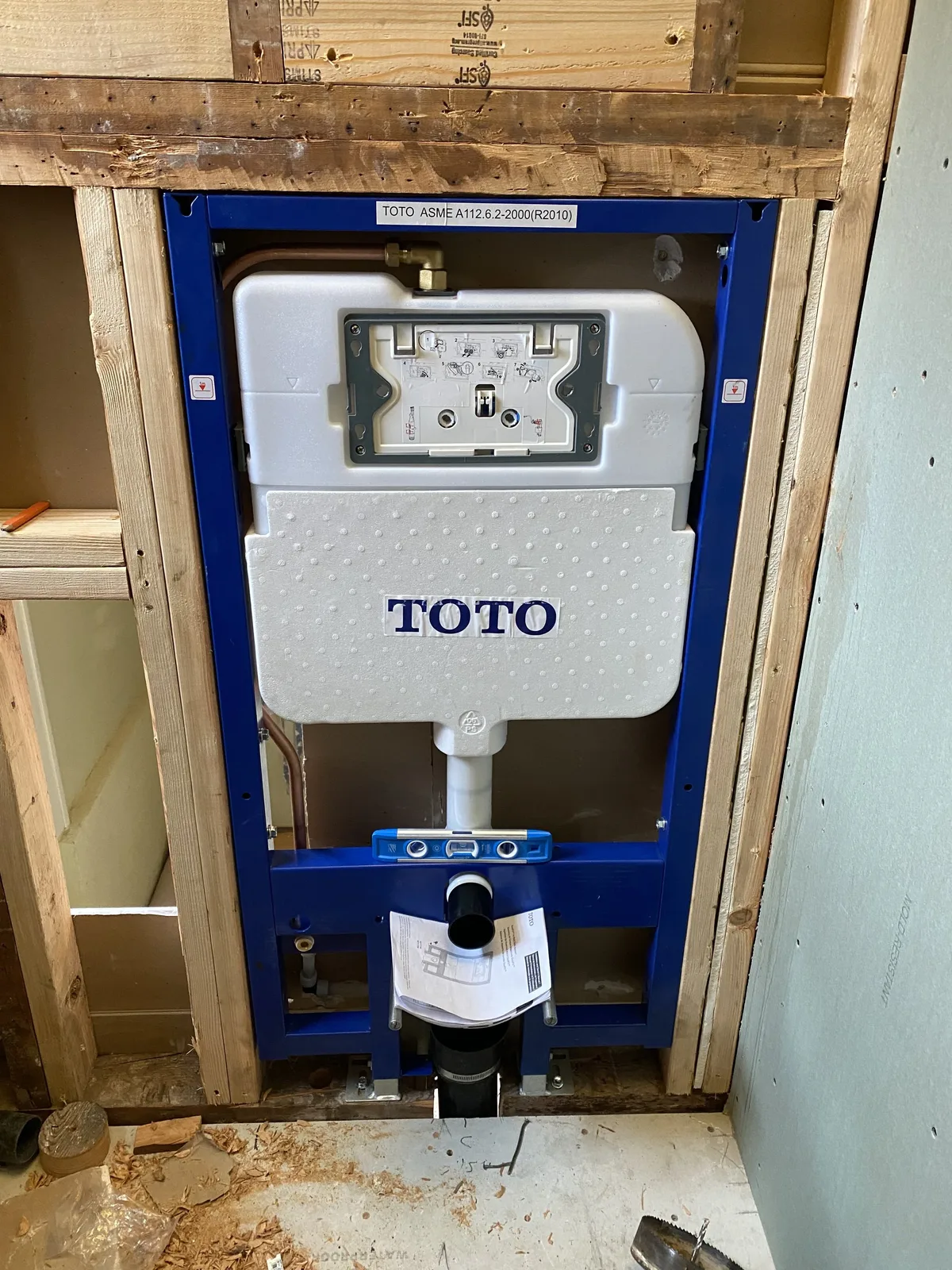 In-wall toilet carrier rough-in during new construction plumbing