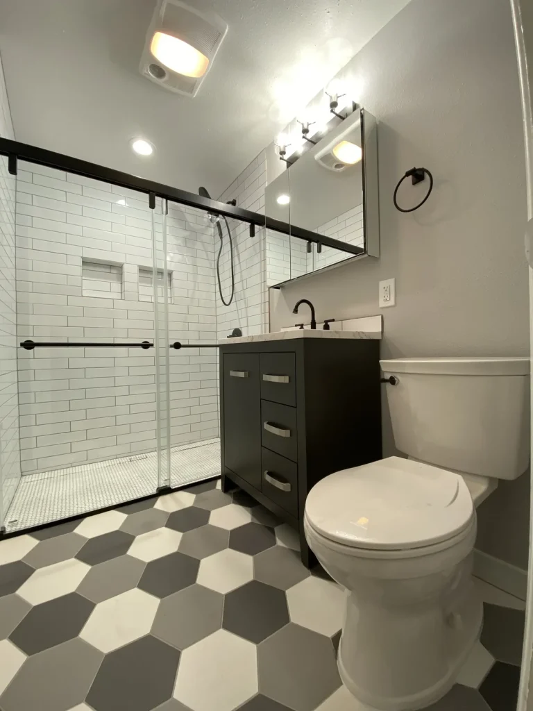 Finished bathroom remodel with a tiled shower and modern fixtures plumbed by Panda Plumbing